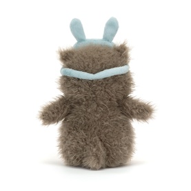 Jellycat small fluffy brown monster plush with pale blue bunny ear headband, seen from the back, textured fur finish.