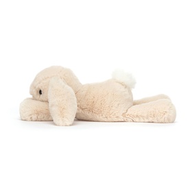 Jellycat cream plush bunny soft toy lying on its side, with fluffy white tail and long floppy ears
