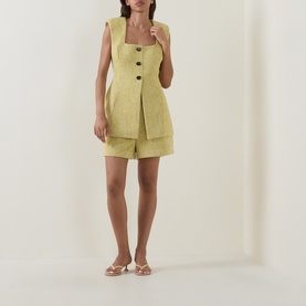 Model wearing Odd Muse Boucl&eacute; Tailored Shorts in chartreuse, styled with matching sleeveless waistcoat and white sandals.