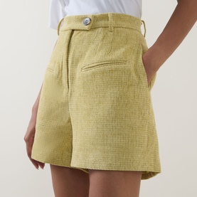 Model wearing Odd Muse Boucl&eacute; Tailored Shorts in chartreuse, high-rise waistband, rear jetted pocket, paired with white top