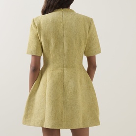 Model wearing Odd Muse Boucl&eacute; Tailored Mini Dress in chartreuse, back view showing dart detailing, flared skirt and short sleeves.
