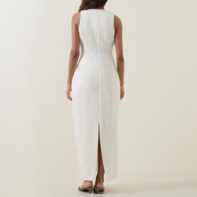 Model wearing Odd Muse Volume Sculpted Dress in ecru, showing back view with rear slit, dart detailing and concealed zip fastening.