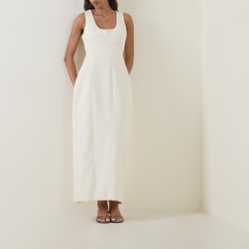 Model wearing Odd Muse Volume Sculpted Dress in ecru, sleeveless scoop neck midi length with waist cinch, styled with strappy flat sandals