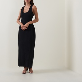 Model wearing Odd Muse Volume Sculpted Dress in black, sleeveless midi length with scoop neckline and waist cinch, styled with strappy heels.