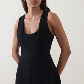 Model wearing Odd Muse Volume Sculpted Dress in black, showing scoop neckline, sleeveless cut and waist-cinching dart detailing.