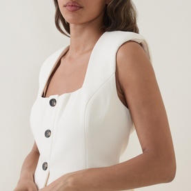 Model wearing Odd Muse Solid Tailored Waistcoat in ecru with square neckline, structured shoulders and dark front buttons