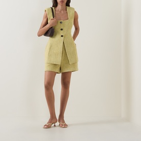 Model wearing Odd Muse Boucl&eacute; Tailored Waistcoat in chartreuse with matching shorts, styled with a dark bag and nude mule heels.