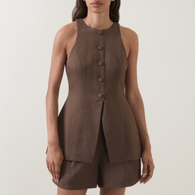 Model wearing Odd Muse Solid Cinched Waistcoat in mushroom, sleeveless with button front and cinched waist, styled with matching shorts.