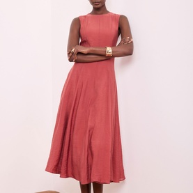 Model wearing Mint Velvet Asymmetric Pleated Dress in red, sleeveless with crew neckline, nipped waist and flared midi-length skirt