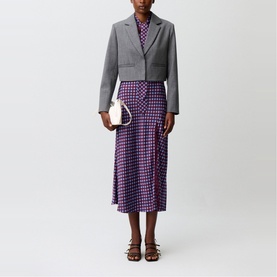Model wearing Claude Pierlot Womens French Dress in purple houndstooth print, styled with grey cropped blazer, brown sandals and white mini bag