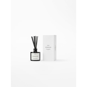 Byredo reed diffuser in black glass vessel with black reeds, shown beside white rectangular box packaging