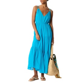 Model wearing Whistles blue tiered maxi dress with spaghetti straps, styled with a woven straw tote bag and flat sandals.