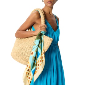 Model carrying large natural straw tote bag with rope handles and printed scarf, styled with Whistles blue maxi dress