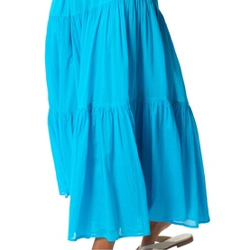 Model wearing Whistles blue tiered maxi skirt in lightweight fabric, styled with white flat sandals.