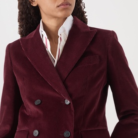 Model wearing Max Mara Weekend Bordeaux corduroy double-breasted blazer with dark buttons, styled with a white striped shirt.