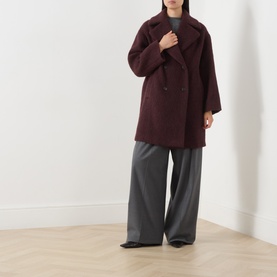 Model wearing Max Mara Weekend Bordeaux wool-blend oversized double-breasted coat, styled with grey wide-leg trousers and black shoes.