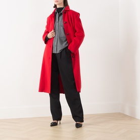 Model wearing Max Mara Weekend red wool coat, styled with grey top, black trousers and black heels.