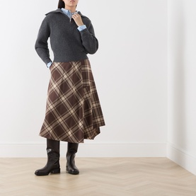 Model wearing Max Mara Weekend Dark Grey wool knit sweater, styled with brown tartan midi skirt and black knee-high boots.