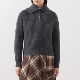 Model wearing Max Mara Weekend dark grey ribbed wool half-zip collar jumper, styled with a brown tartan midi skirt.