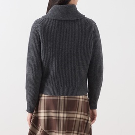 Model wearing Max Mara Weekend dark grey ribbed wool knit, back view, styled with brown tartan midi skirt.