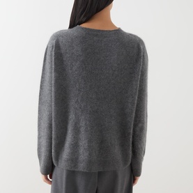 Model wearing Max Mara Weekend dark grey wool cashmere blend sweater, rear view, styled with matching grey trousers