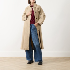 Model wearing Max Mara Weekend Tuono Knitted Sweater in Bordeaux, styled with a beige trench coat, wide-leg jeans and black loafers.