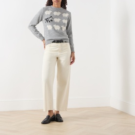 Model wearing Max Mara Weekend Light Grey knit jumper with sheep intarsia, styled with cream trousers and black loafers.