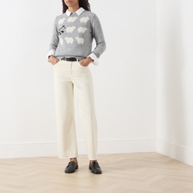 Model wearing Max Mara Weekend light grey sheep-intarsia knit, styled with white collar shirt, cream wide-leg jeans and black loafers.