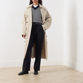 Model wearing Max Mara Weekend navy striped wool knit, styled with a beige trench coat, black wide-leg trousers and black loafers.