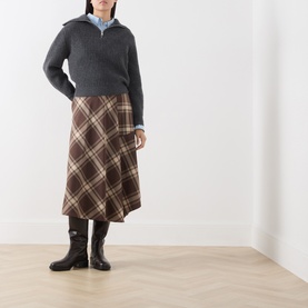 Model wearing Max Mara Weekend brown tartan check midi skirt, styled with grey zip-neck knit and black knee-high boots.