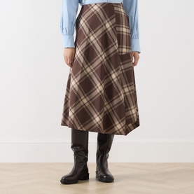 Model wearing Max Mara Weekend brown check midi skirt in virgin wool blend, styled with blue top and dark knee-high boots.
