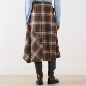 Model wearing Max Mara Weekend brown check midi skirt in wool blend, shown from behind, styled with blue shirt and dark knee-high boots.