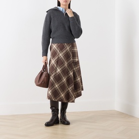 Model wearing Max Mara Weekend brown check wool midi skirt, styled with grey knit, blue shirt, black boots, and brown bag.