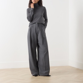Model wearing Max Mara Weekend Kiku Turtleneck Sweater in dark grey with wide-leg grey tailored trousers.