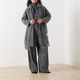 Model wearing Max Mara Weekend Kiku Turtleneck Sweater in dark grey, styled with a fringed coat and wide-leg trousers.