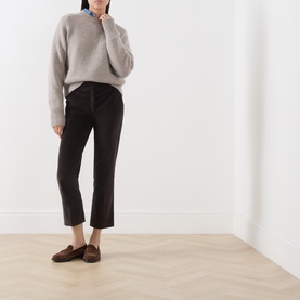 Model wearing Max Mara Weekend Dark Brown cotton trousers, styled with a grey knit sweater and brown loafers.
