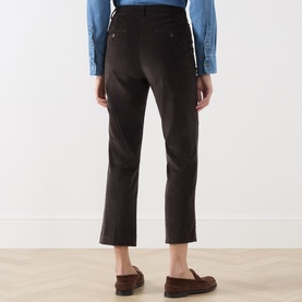 Model wearing Max Mara Weekend dark brown cotton trousers, rear view, styled with blue shirt and tan loafers