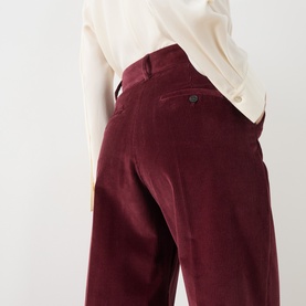 Model wearing Max Mara Weekend Tania Corduroy Straight-Leg Trousers in bordeaux, styled with a cream blouse. Mid-rise, straight-leg silhouette.
