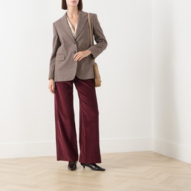 Model wearing Max Mara Weekend Tania Corduroy Straight-Leg Trousers in Bordeaux, styled with a checked blazer and small tan shoulder bag.
