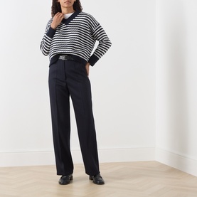 Model wearing Max Mara Weekend ultramarine wide-leg wool trousers with a navy striped knit and black leather belt and loafers.