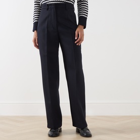 Model wearing Max Mara Weekend Ultramarine wide-leg wool trousers, styled with a striped knit and black loafers.