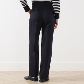 Model wearing Max Mara Weekend Ultramarine wool wide-leg trousers, rear view, styled with a stripe knit and black loafers.