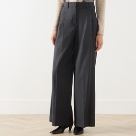 Model wearing Max Mara Weekend dark grey wide-leg virgin wool trousers with pressed pleats, styled with a cream knit top.