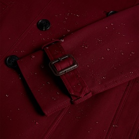 Hobbs fig purple coat close-up showing silver buckle belt detail and water-resistant fabric finish with button fastening.