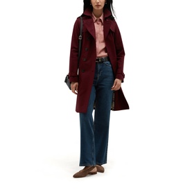 Model wearing Hobbs fig purple trench coat, styled with pink shirt, blue wide-leg jeans, brown loafers and black crossbody bag