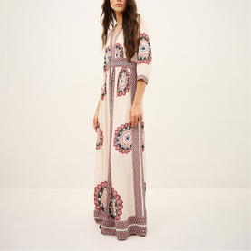 Model wearing Bash cream maxi dress with V-neck, 3/4 sleeves, and bold medallion print in pink and red tones