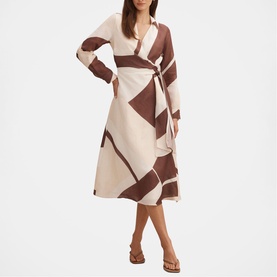 Model wearing Forever New Driftwood Geo midi wrap dress with long sleeves, styled with tan flat sandals