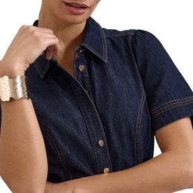 Model wearing Phase Eight blue denim short-sleeve shirt dress with gold-tone buttons, styled with a gold textured cuff bracelet