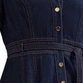 Phase Eight blue denim dress close-up showing gold snap buttons, contrast stitching, and self-tie belted waist
