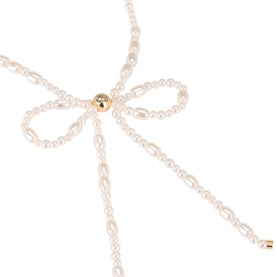 Coach Bow Pearl Choker Necklace in pearl and gold tone, featuring faux pearl bow motif with gold logo centrepiece and drop tails